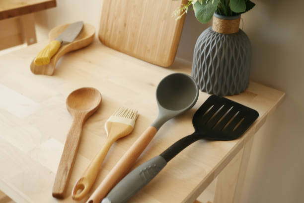 Master craftsmen hand-finishing copper cookware and kitchen tools in artisan workshop